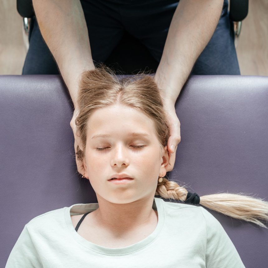 Osteopathic treatment of a girl patient using CST gentle hands-on technique, central nervous system