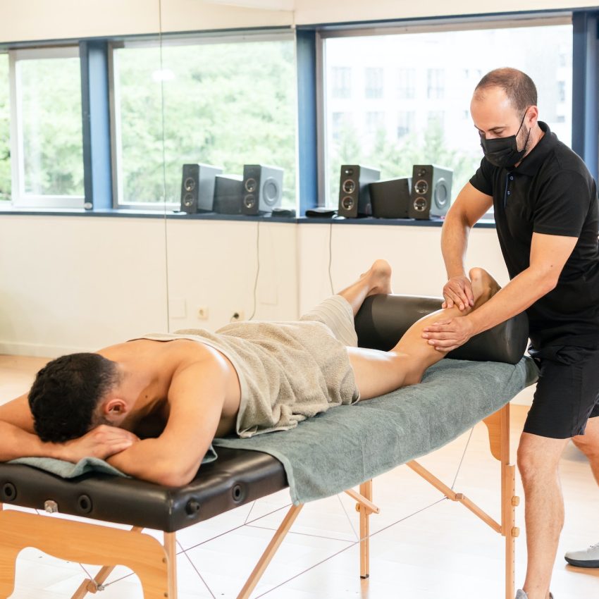 Therapeutic leg massage and sports recovery osteopathy. A sporty man receiving